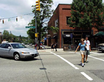 Pedestrians crossing the street on crosswalk