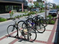 Raised median islands narrow the street and offer a safe pedestrian refuge.