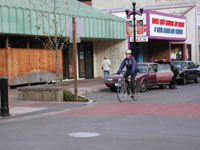 Parking bays, raised intersections, and narrow lanes help calm traffic.