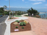 An off-road space for bicyclists and pedestrians to connect to an ocean-front park with a marina and shopping district.