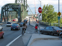 After: Eastbound Hawthorne Bridge access to sidewalks. Bicyclists proceed straight, motorists stop