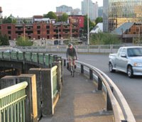 Before: Steel Bridge, upper deck. Bicyclists and pedestrians sharing one 5-foot sidewalk with guardrail.