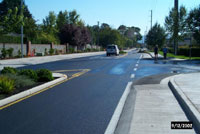 Water ponding created by asphalt paving created challenges around curb return.