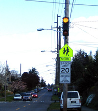 After: Modified reduced speed zone sign used in conjunction with a flashing beacon.