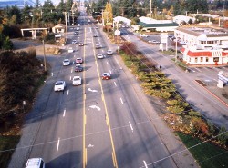 Bridgeport Way prior to the redesign, with two travel lanes in each direction, a center left-turn lane, and not sidewalk or bike lanes.