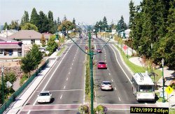 Bridgeport Way after the redesign, with two lanes in each direction, a median, bike lanes, and sidewalk.