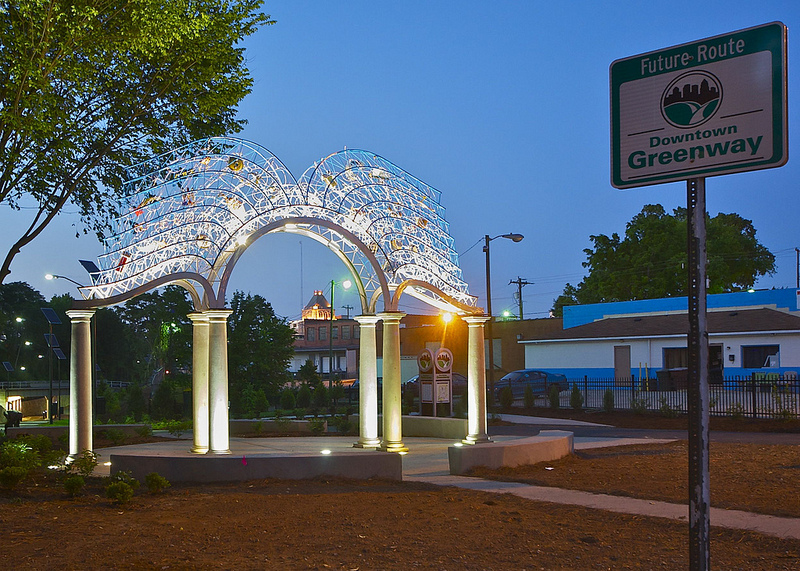 A public art installation, which resembles a archway with an open book across the top.