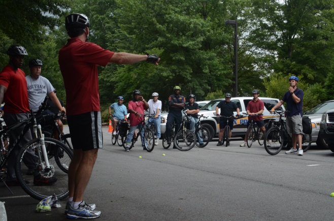 Law enforcement officers participate in hands-on exercises about bicycle safety.