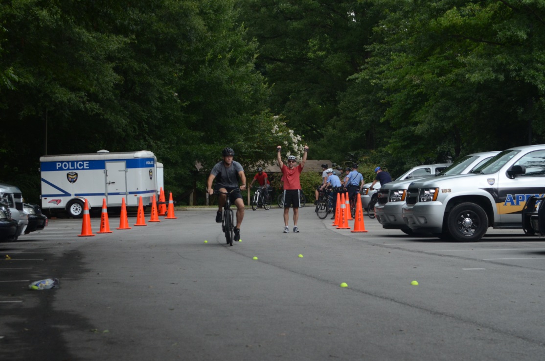 Law enforcement officers participate in hands-on exercises about bicycle safety.