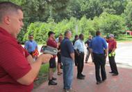 Law enforcement officers participate in hands-on exercises about pedestrian safety.