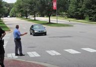 Law enforcement officers participate in hands-on exercises about pedestrian safety.