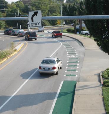 One of two green merge-and-weave intersection treatments.