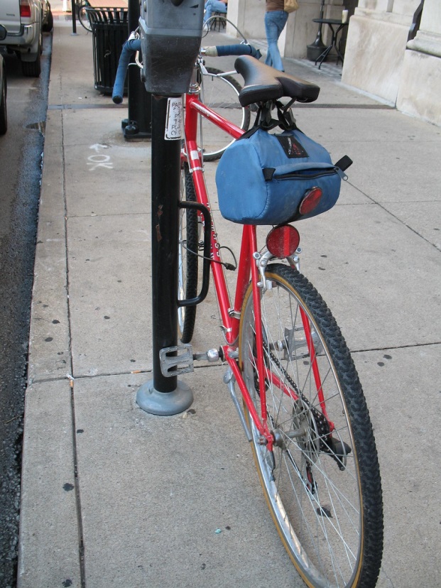 Parking meters in downtown Columbia are outfitted with metal loops for bike parking.